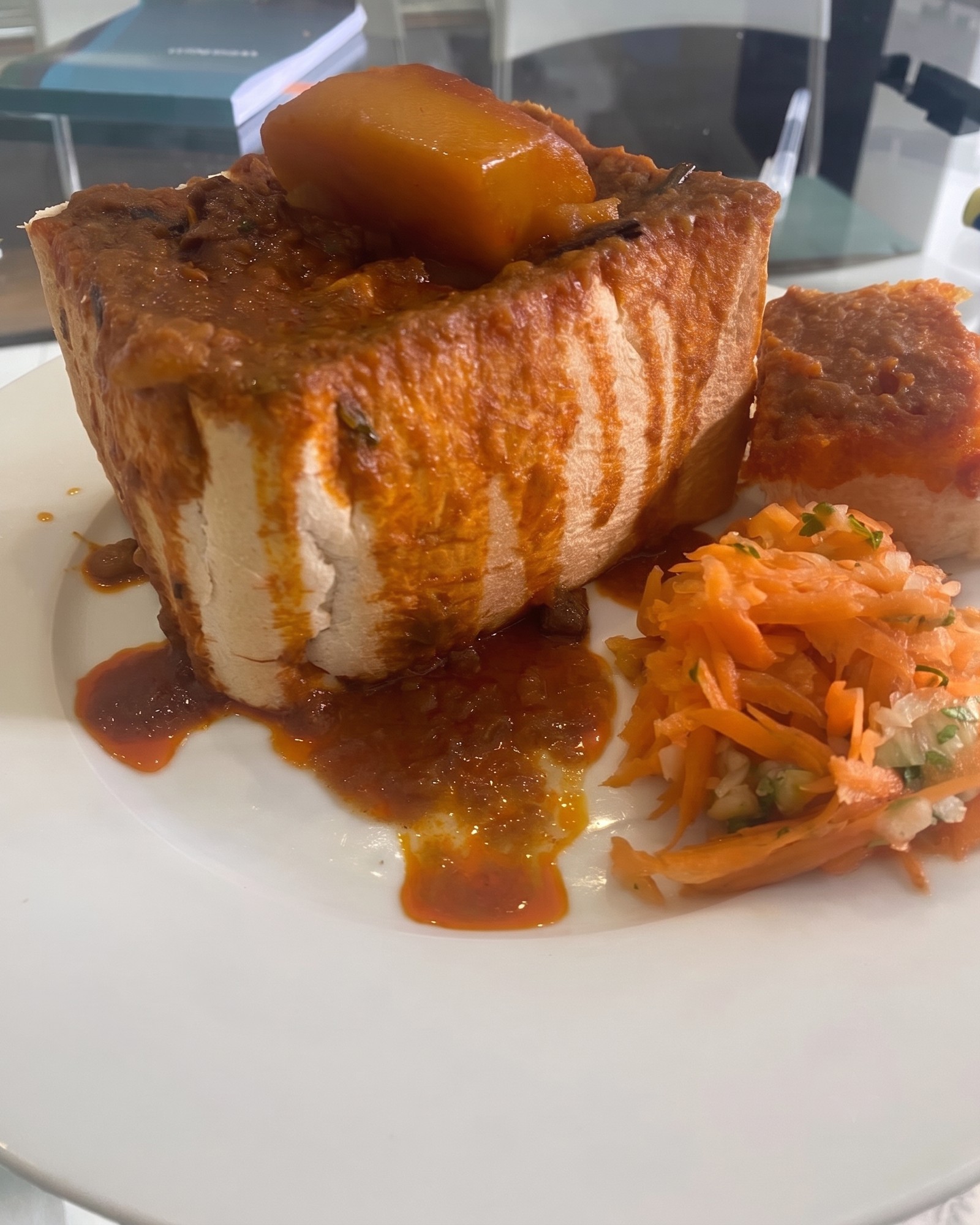 Durban bunny chow topped with potato and served with carrot salad