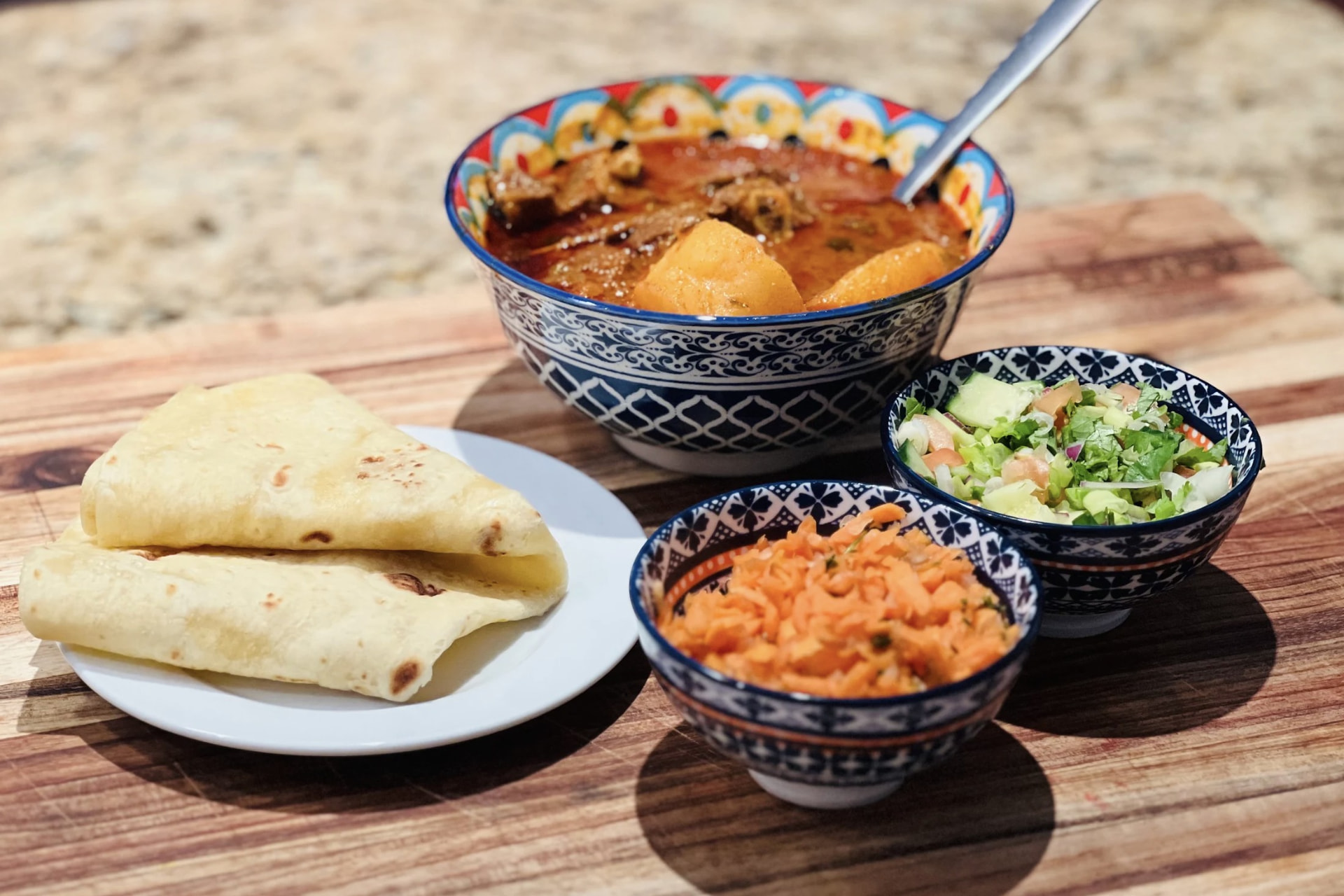 Lamb curry with roti, carrot salad and fresh salad